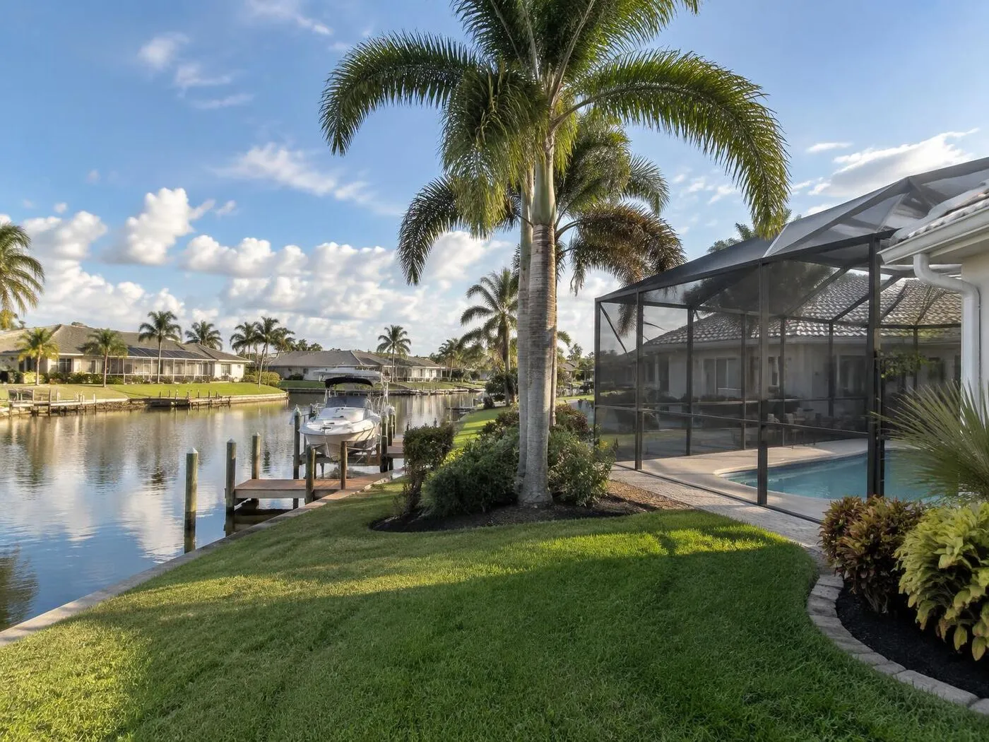 Canal-front Port Charlotte home with a screened pool enclosure and boat dock